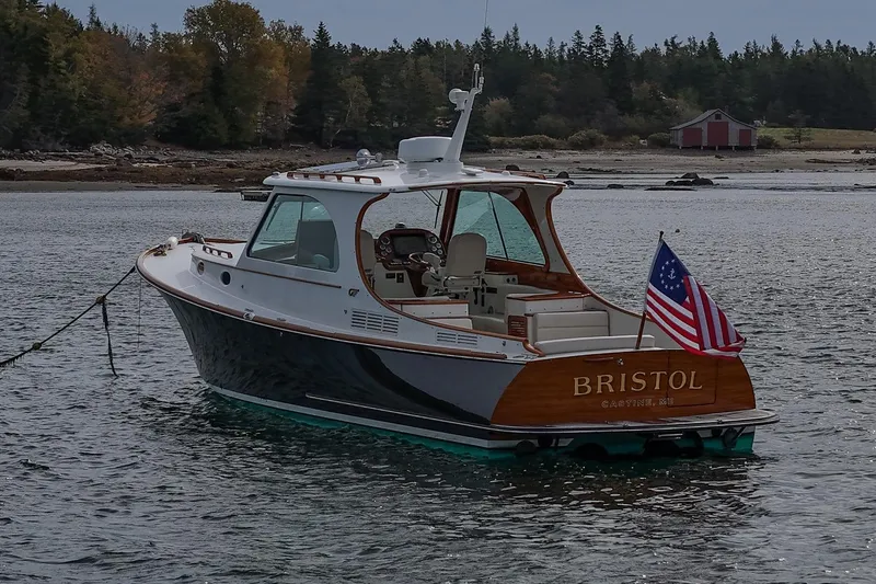 Slide: The Image of 2015 Hinckley Picnic Boat 37 MKIII on water, American flag, scenic background. - 20