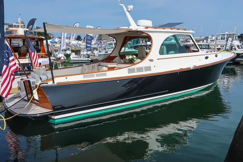 Slide: The Image of 2015 Hinckley Picnic Boat 37 MKIII docked at marina, showcasing elegant design. - 21