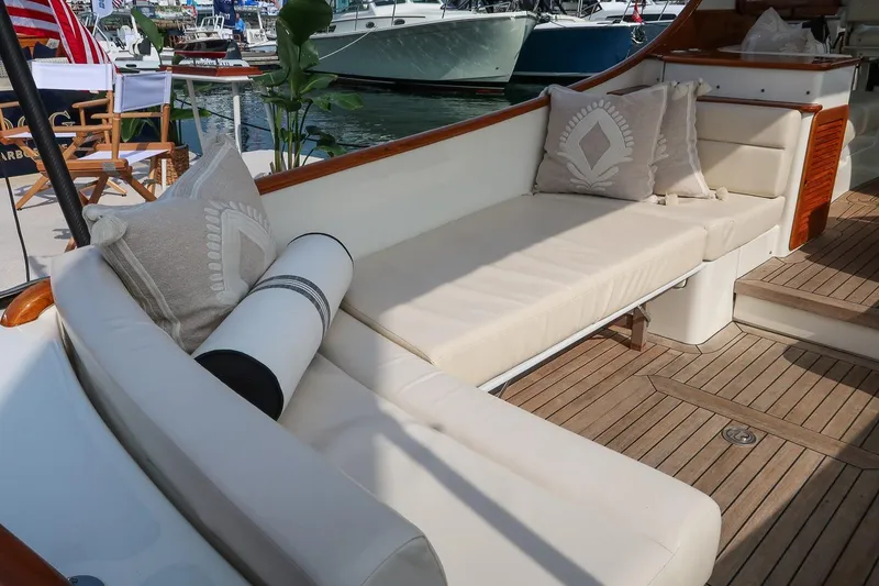 Slide: The Image of Luxurious seating area on 2015 Hinckley Picnic Boat 37 MKIII with elegant cushions and teak flooring. - 30