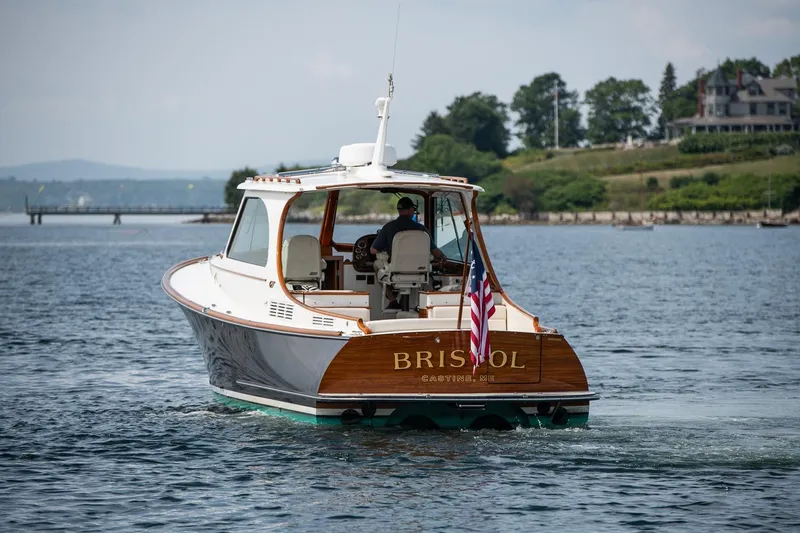 Slide: The Image of 2015 Hinckley Picnic Boat 37 MKIII cruising on a scenic waterway. - 10