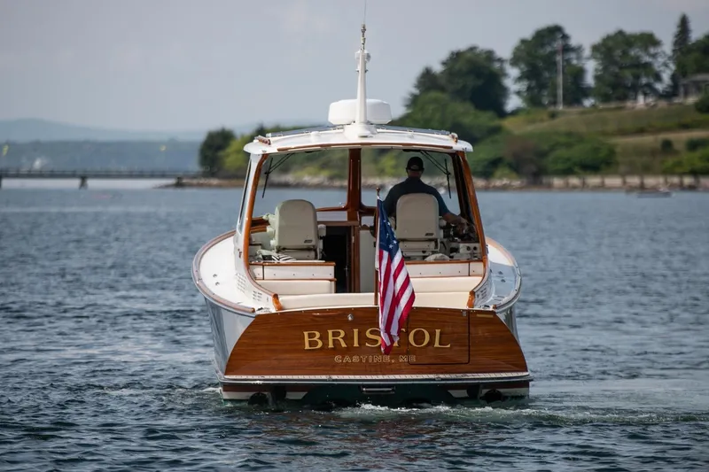 Slide: The Image of 2015 Hinckley Picnic Boat 37 MKIII cruising on a scenic waterway. - 11