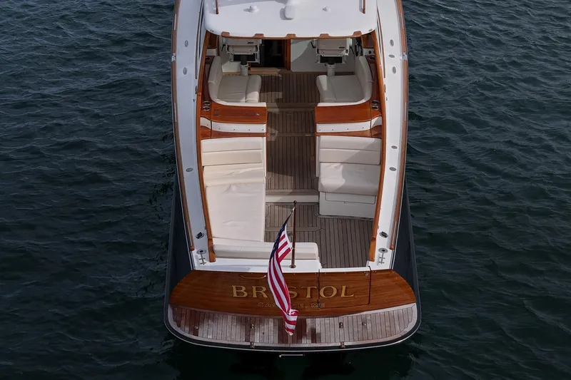 Slide: The Image of 2015 Hinckley Picnic Boat 37 MKIII on water, elegant design, spacious seating, American flag displayed. - 18