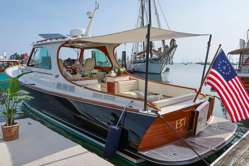 Slide: The Image of 2015 Hinckley Picnic Boat 37 MKIII docked with American flag and canopy. - 22