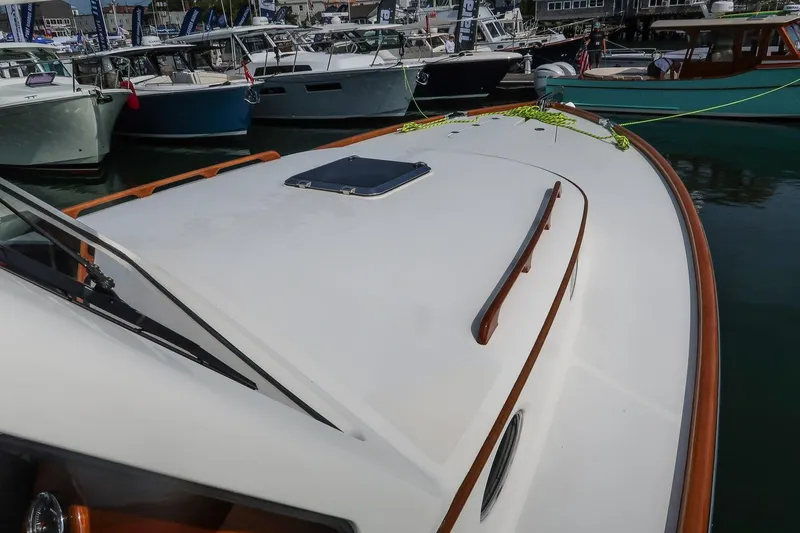 Slide: The Image of 2015 Hinckley Picnic Boat 37 MKIII docked among other boats at a marina. - 24
