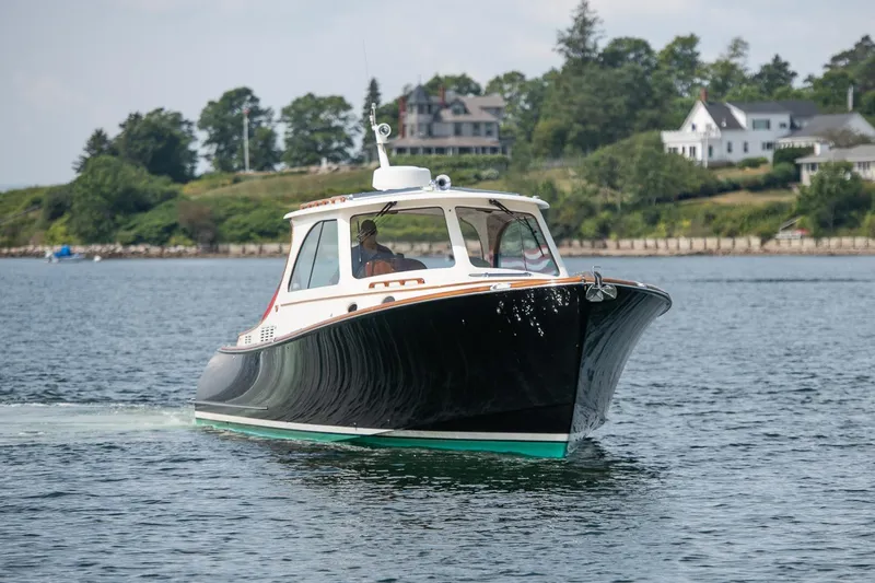 Slide: The Image of 2015 Hinckley Picnic Boat 37 MKIII cruising on a scenic waterway. - 3