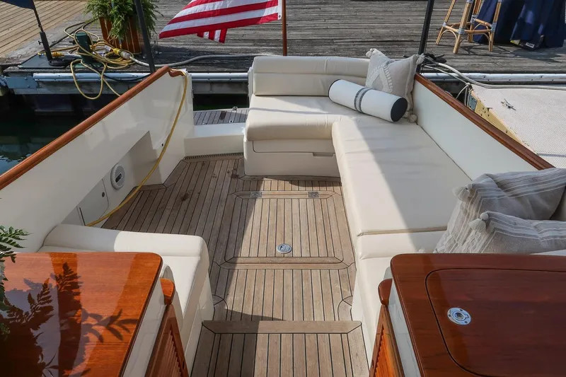 Slide: The Image of Luxurious seating area on a 2015 Hinckley Picnic Boat 37 MKIII with teak flooring. - 31