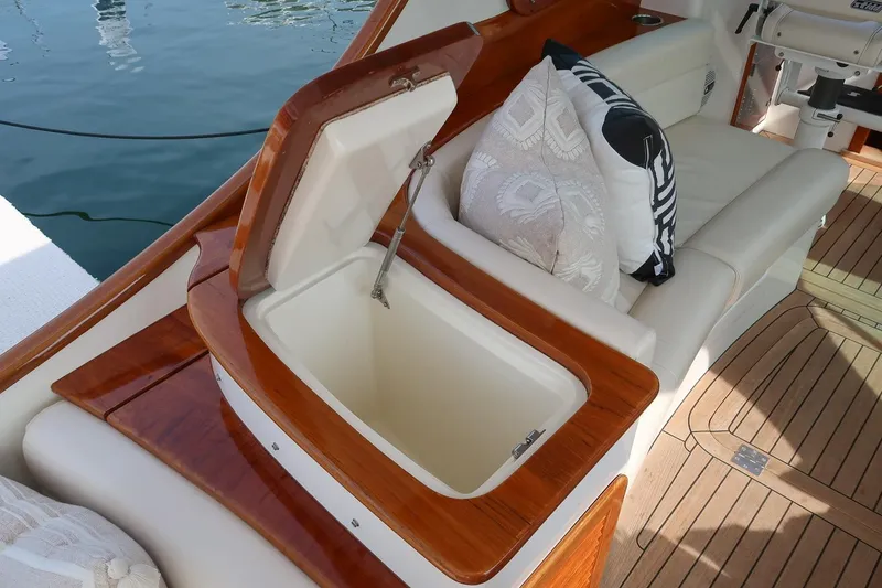 Slide: The Image of 2015 Hinckley Picnic Boat 37 MKIII interior with open storage compartment and cushioned seating. - 32