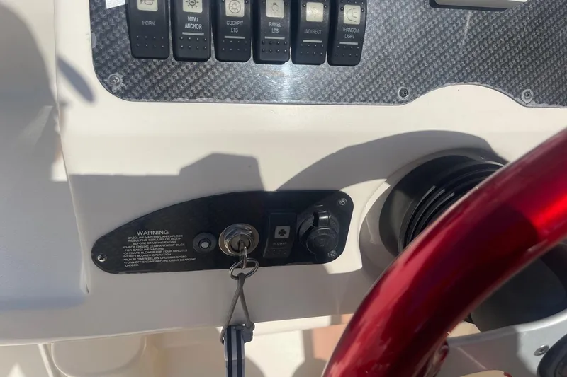 Slide: The Image of 2001 Rinker 262 Captiva dashboard with ignition key and control switches. - 11