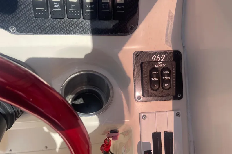 Slide: The Image of Control panel of 2001 Rinker 262 Captiva boat with Lenco trim tab switches. - 12