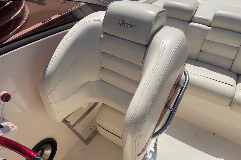 Slide: The Image of White leather seat on 2001 Rinker 262 Captiva boat interior. - 14