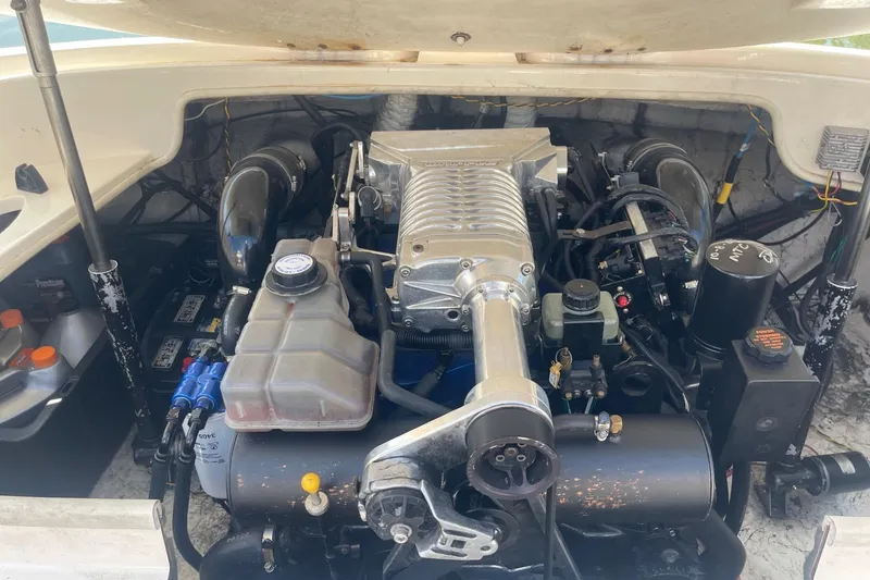 Slide: The Image of Engine compartment of a 2001 Rinker 262 Captiva boat, showcasing detailed components. - 19
