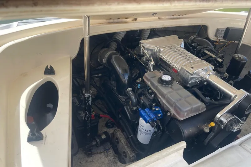 Slide: The Image of Engine compartment of a 2001 Rinker 262 Captiva boat, showcasing detailed components. - 21