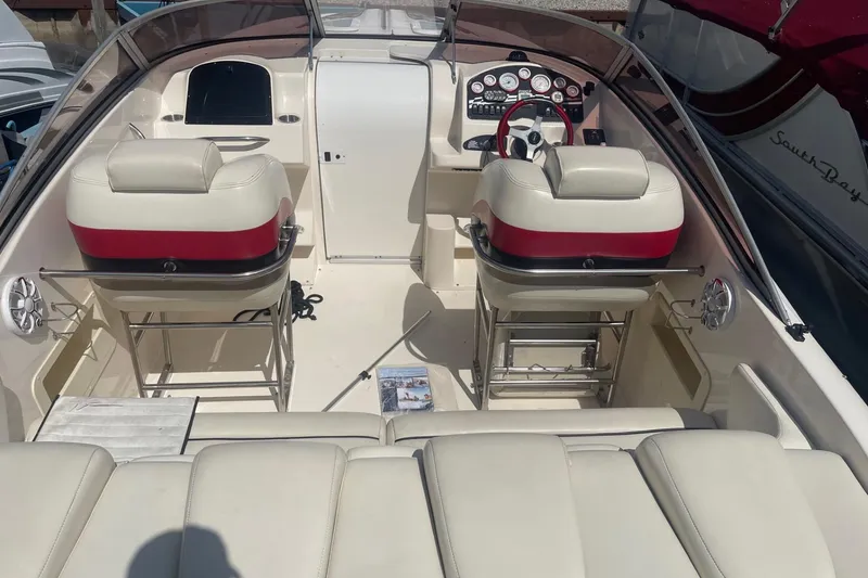 Slide: The Image of 2001 Rinker 262 Captiva boat interior with dual seats and control panel. - 3
