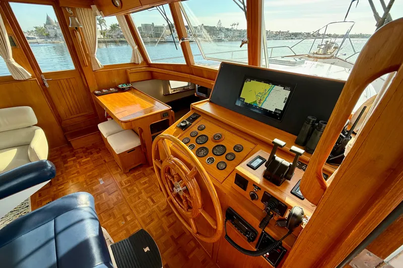Slide: The Image of Helm of 2001 Grand Banks 46 Classic yacht with wooden interior and navigation equipment. - 14