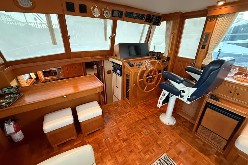Slide: The Image of Elegant 2001 Grand Banks 46 Classic yacht interior with helm, seating, and wood finishes. - 15