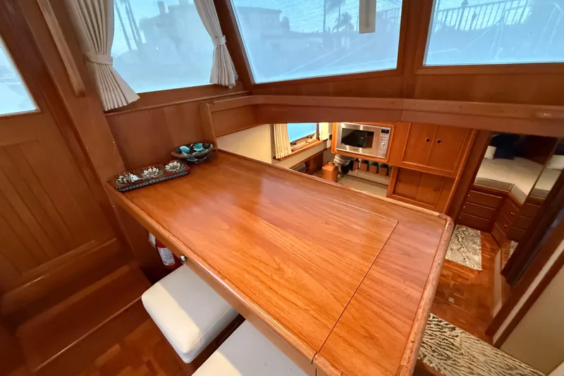 Slide: The Image of Luxurious interior of 2001 Grand Banks 46 Classic yacht with wooden dining area. - 28