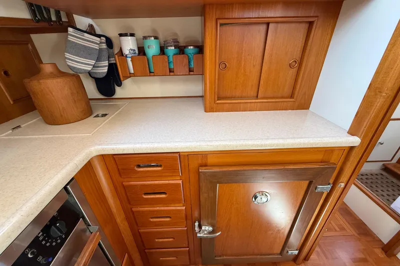 Slide: The Image of Wooden galley interior of 2001 Grand Banks 46 Classic yacht with countertop and storage. - 30