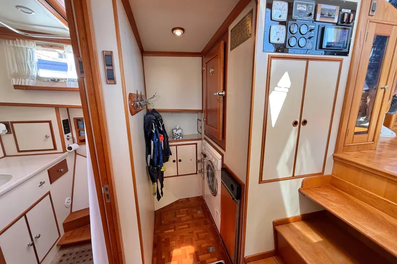 Slide: The Image of Interior of 2001 Grand Banks 46 Classic yacht, featuring wood accents and laundry area. - 35