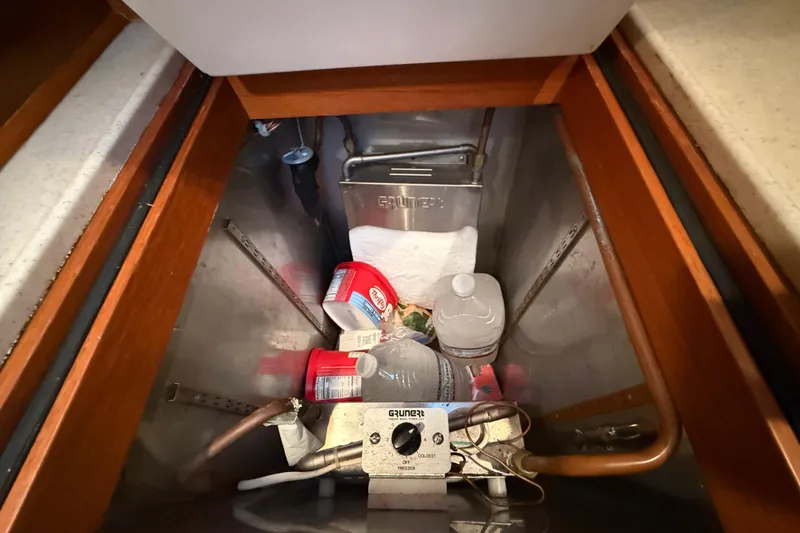 Slide: The Image of Storage compartment in 2001 Grand Banks 46 Classic yacht with various items and equipment. - 37