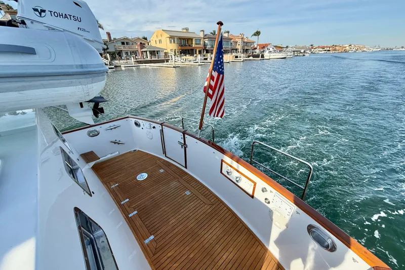 Slide: The Image of Grand Banks 46 Classic yacht, 2001 model, cruising in a scenic waterfront area. - 41