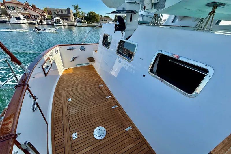 Slide: The Image of 2001 Grand Banks 46 Classic yacht deck with wooden flooring and marina view. - 42