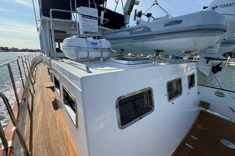 Slide: The Image of 2001 Grand Banks 46 Classic yacht with wooden deck and mounted dinghy. - 44