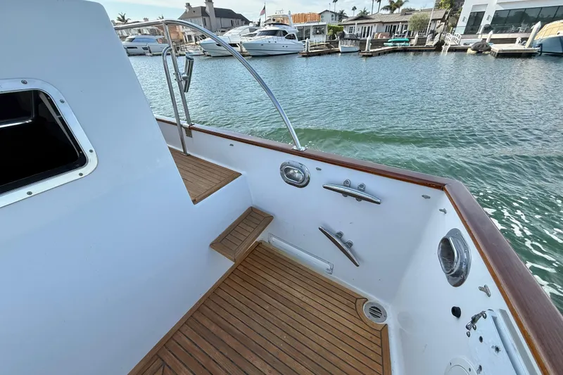Slide: The Image of 2001 Grand Banks 46 Classic yacht deck with wooden flooring and marina view. - 45