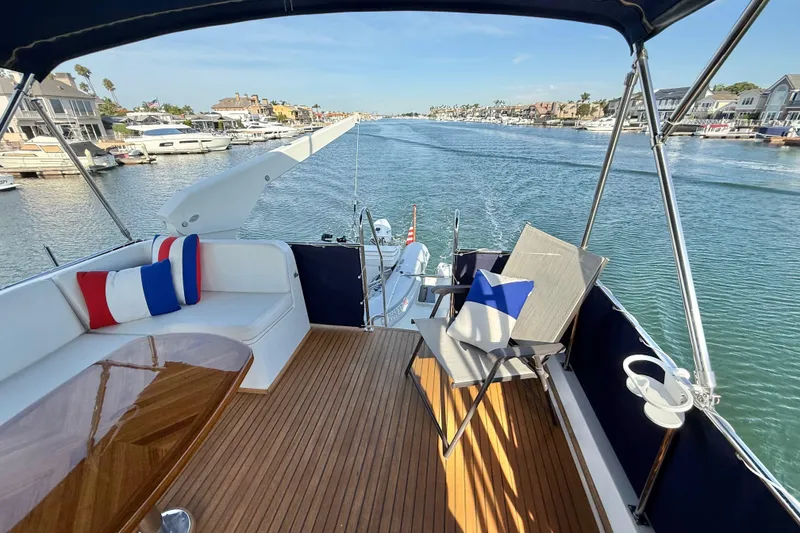 Slide: The Image of Deck view of 2001 Grand Banks 46 Classic yacht with seating and scenic waterfront. - 49