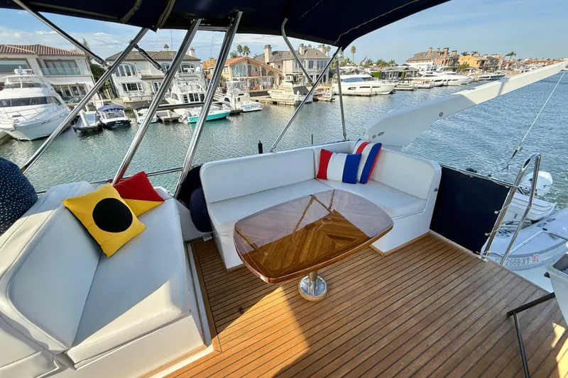 Slide: The Image of Luxurious 2001 Grand Banks 46 Classic yacht with elegant seating and waterfront view. - 50