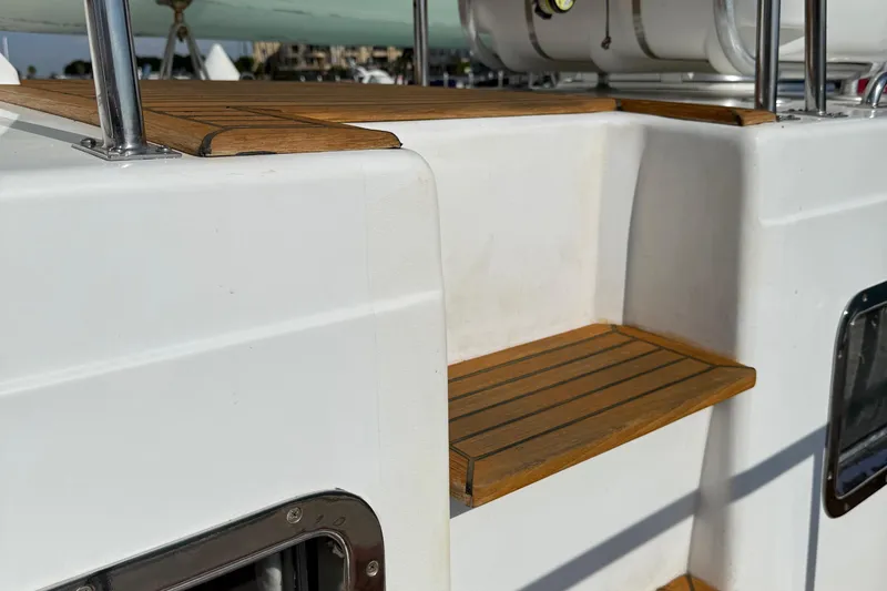 Slide: The Image of Teak steps on a 2001 Grand Banks 46 Classic yacht deck. - 54