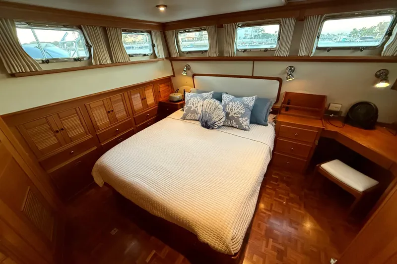 Slide: The Image of Luxurious cabin interior of 2001 Grand Banks 46 Classic yacht with cozy bed and wooden furnishings. - 57