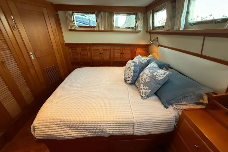 Slide: The Image of Luxurious bedroom interior of 2001 Grand Banks 46 Classic yacht with elegant wood finish. - 58