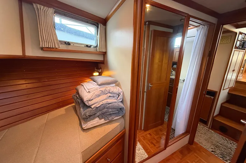 Slide: The Image of Cozy cabin interior of 2001 Grand Banks 46 Classic yacht with wooden finishes. - 66
