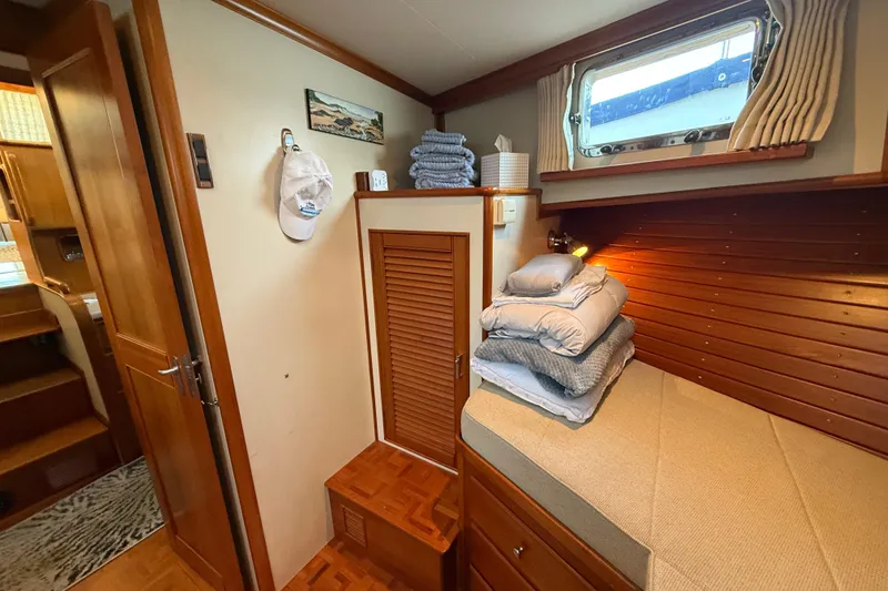 Slide: The Image of Cozy cabin interior of 2001 Grand Banks 46 Classic yacht with bedding and wooden accents. - 67