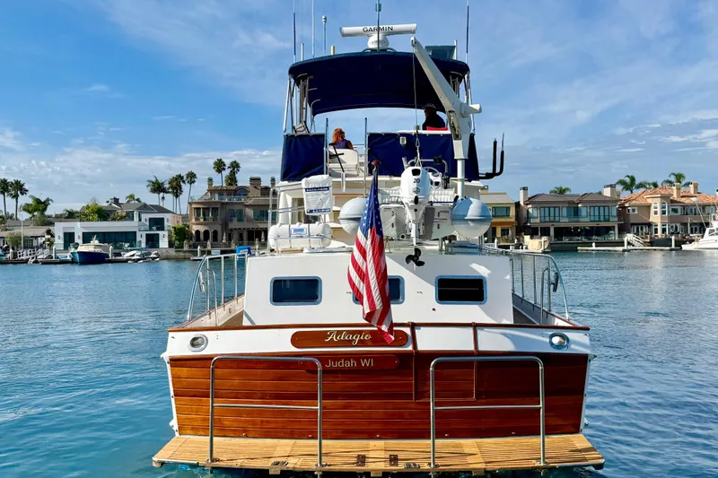 Slide: The Image of Grand Banks 46 Classic yacht, 2001 model, docked in a scenic waterfront area. - 7