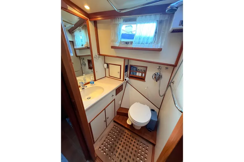Slide: The Image of Bathroom interior of 2001 Grand Banks 46 Classic yacht, featuring sink, toilet, and shower. - 70