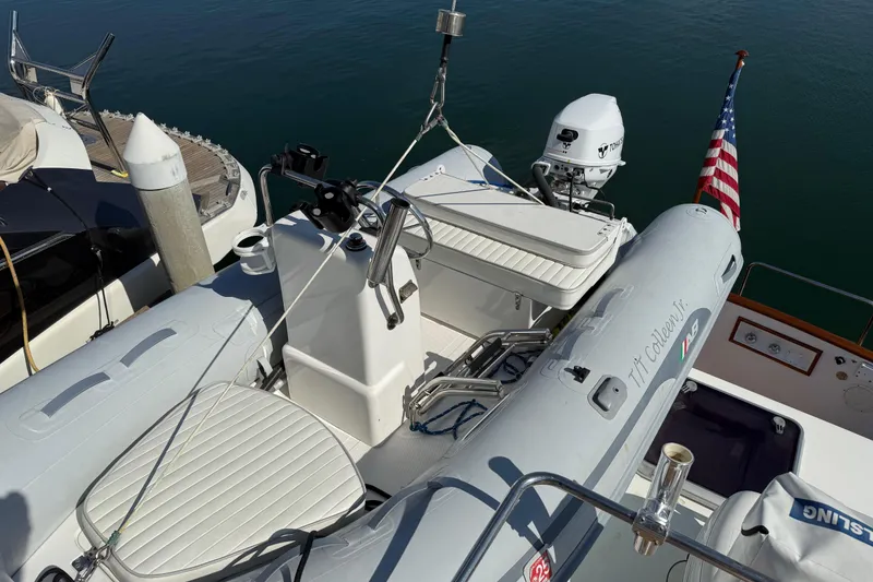 Slide: The Image of 2001 Grand Banks 46 Classic yacht with inflatable boat and American flag. - 75