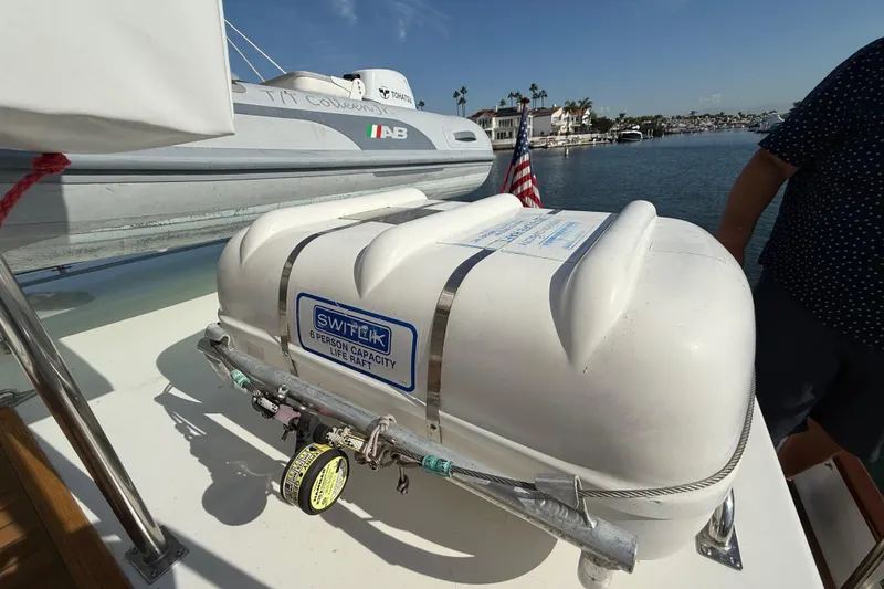 Slide: The Image of Life raft on 2001 Grand Banks 46 Classic yacht, docked near waterfront homes. - 76