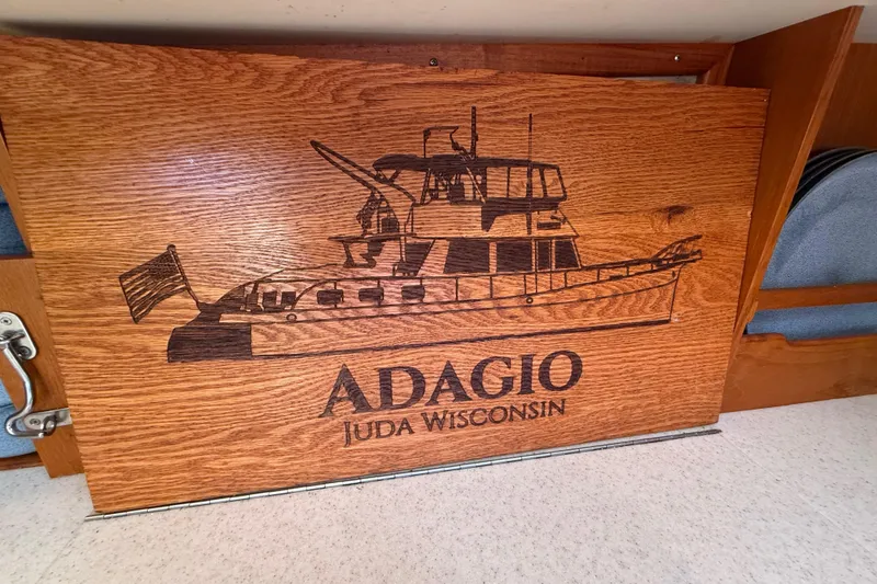 Slide: The Image of Engraved wooden panel of Grand Banks 46 Classic, 2001, with "Adagio" and "Juda Wisconsin." - 79