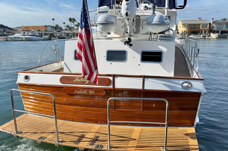 Slide: The Image of Grand Banks 46 Classic yacht, 2001 model, docked with American flag displayed. - 8