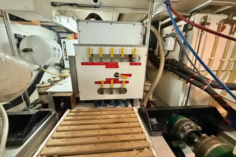 Slide: The Image of Engine room of 2001 Grand Banks 46 Classic yacht, featuring control panel and machinery. - 83