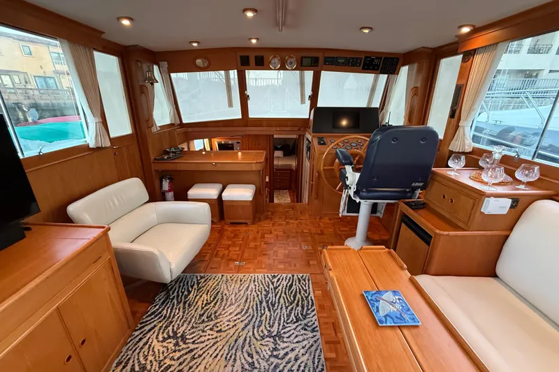 Slide: The Image of Luxurious 2001 Grand Banks 46 Classic yacht interior with elegant wood finishes and comfortable seating. - 9