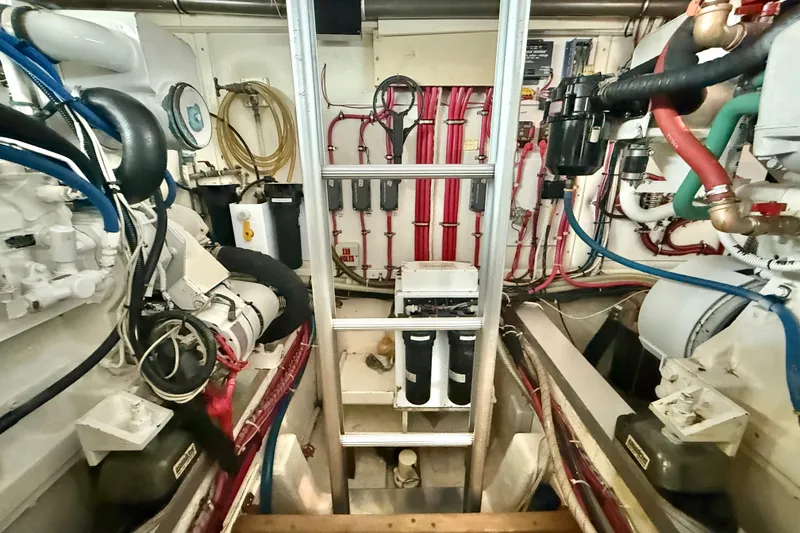 Slide: The Image of Engine room of 2001 Grand Banks 46 Classic yacht, featuring complex piping and machinery. - 90