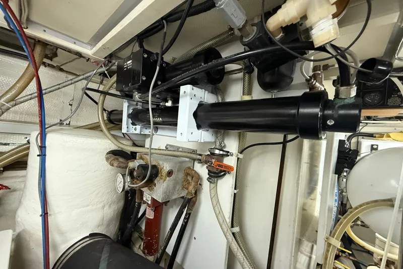 Slide: The Image of Engine room of 2001 Grand Banks 46 Classic yacht, showcasing mechanical components and piping. - 93