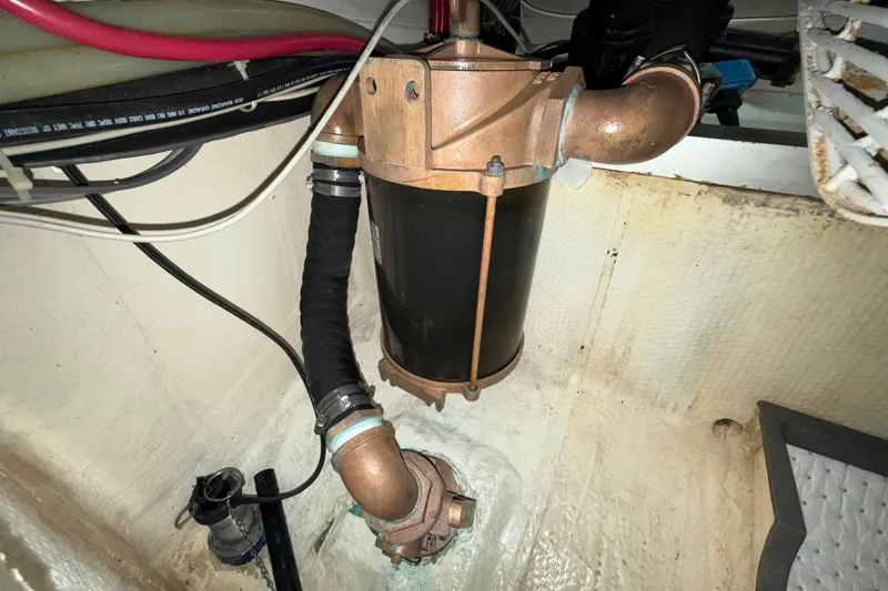 Slide: The Image of Engine room of 2001 Grand Banks 46 Classic yacht, showing mechanical components and piping. - 94