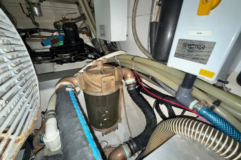 Slide: The Image of Engine room of 2001 Grand Banks 46 Classic yacht with various mechanical components. - 95