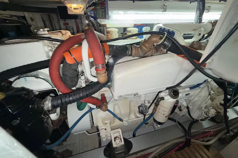 Slide: The Image of Engine room of a 2001 Grand Banks 46 Classic yacht, showcasing detailed mechanical components. - 97