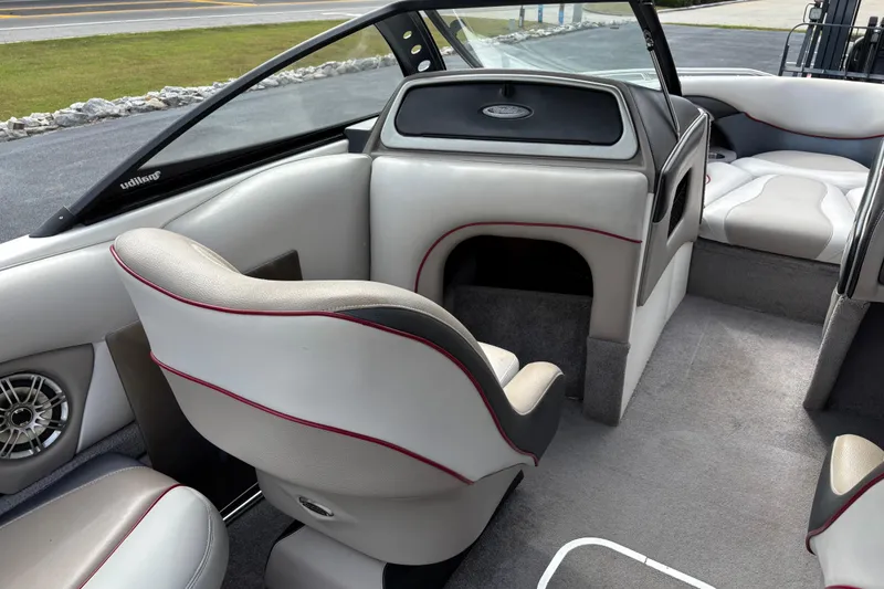 Slide: The Image of 2008 Malibu Wakesetter 23 LSV interior with gray and white seating, red accents, and speaker. - 10