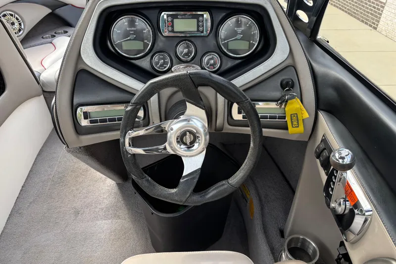 Slide: The Image of 2008 Malibu Wakesetter 23 LSV dashboard with steering wheel and control panel. - 9