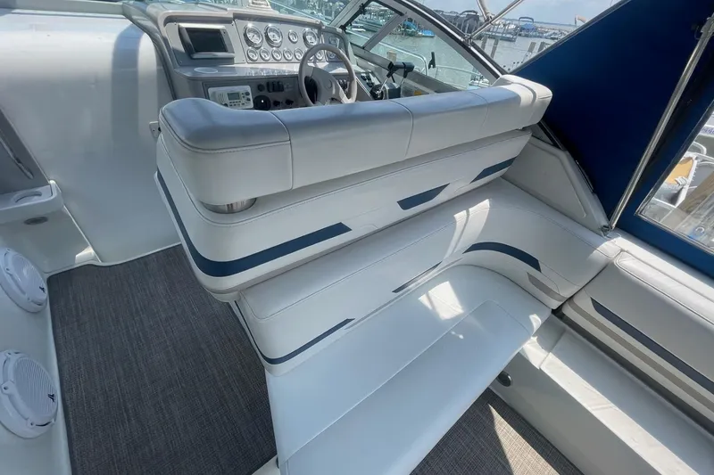 Slide: The Image of 1999 Formula 31 Performance Cruiser interior with white seating and built-in speakers. - 13